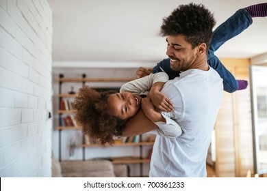 Cute African American Kid Playing With Her Dad.