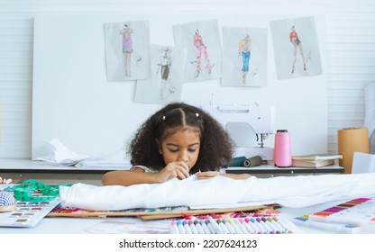 Cute African Little Girl Sewing Clothes, Design Dress At Tailor Room, Cozy Home As Her Career Dream, Smiling With Happiness And Fun. Leisure, Lifestyle, Education, Kid Concept