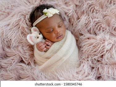 Cute African Newborn Baby Hugging Mice Toy