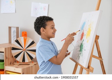 Cute African-American boy painting at school - Powered by Shutterstock