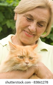 cute aged woman with cat at nature