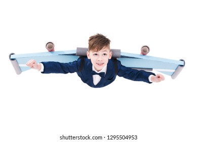 Cute Ambitious Little Kid In Suit Flying With Jet Pack Wings Isolated On White Background, Big Dreams And Success Concept