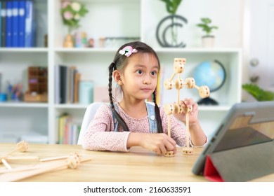 Cute Asian 6 Years Old Asian Little Girl Is Present Her Wooden Robot To Online Classroom, Concept Of Creativity, Learning, Virtual, Connect And Technology, Montessori, Education And Kid Development.