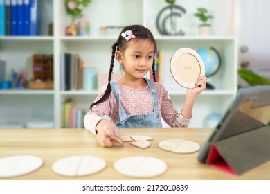 Cute Asian 6 Years Old Asian Little Girl Is Studying Time By Wooden Clock Online Classroom, Concept Of Creativity, Learning, Virtual, Connect And Technology, Montessori, Education And Kid Development.