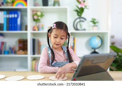 Cute Asian 6 Years Old Asian Little Girl Is Studying Time By Wooden Clock Online Classroom, Concept Of Creativity, Learning, Virtual, Connect And Technology, Montessori, Education And Kid Development.