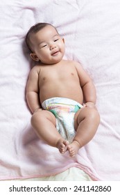 Cute Asian Baby Girl In Diaper Lay Down On Blanket Sheet