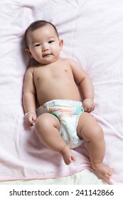 Cute Asian Baby Girl In Diaper Lay Down On Blanket Sheet