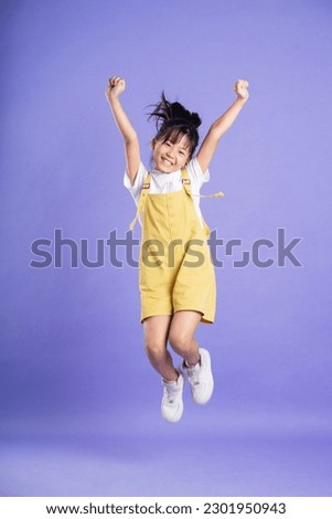 cute asian baby girl posing on purple background