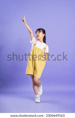 cute asian baby girl posing on purple background