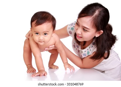 Cute Asian Baby Learning To Walk, Guided By Her Mother, Isolated On White Background