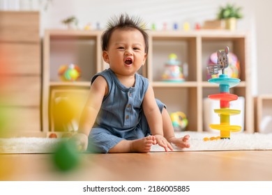 Cute Asian baby playing educational toys to learning and develop skill at home. Adorable cheerful baby toddler enjoy with toys in Nursery. Development skill in baby concept
