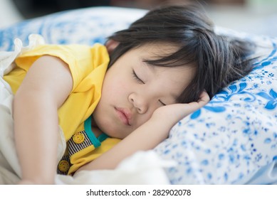 Cute Asian Baby Sleeping On Bed