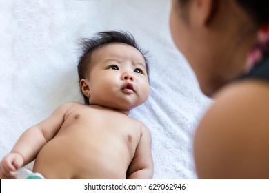 Cute Asian baby talk to mom with happy,  2 months after birth.