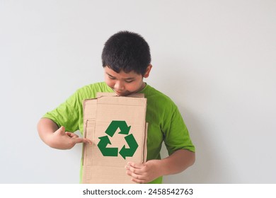 Cute Asian boy holding Cardboard for recycle. Cardboard recycling. Recycling concept. - Powered by Shutterstock