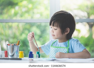 Cute Asian Boy Painting A Picture