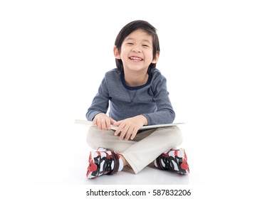 Cute Asian Boy Reading A Book On White Background Isolated