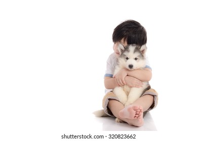 Cute Asian Boy Sitting With Siberian Husky Puppy On White Background Isolated