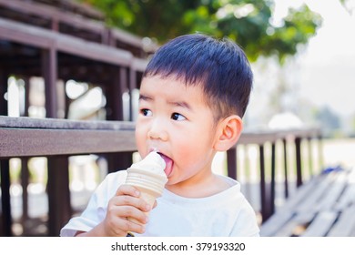 Cute Asian child eating icecream