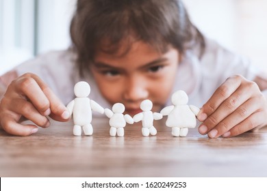 Cute asian child girl playing with plasticine clay happy family with fun. Happy family concept. - Powered by Shutterstock