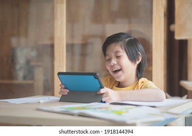 Cute Asian child learning class study online with video call from tablet at home .Social distancing  concept - Powered by Shutterstock