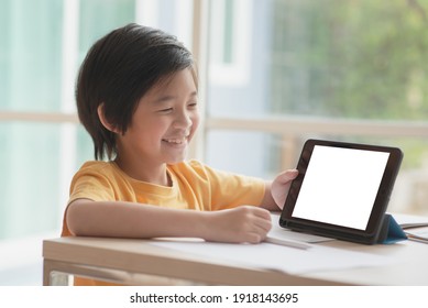 Cute Asian Child Playing With A Blank Screen Tablet 