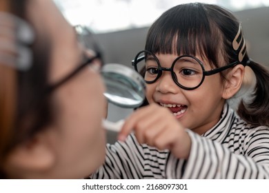 Cute Asian Child Playing With Doctor Dentist Toy Set, Child Shows How To Clean And Care For Teeth. Dentistry And Medicine,