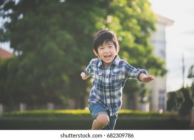 Cute Asian Child Playing In The Park