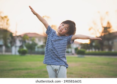 Cute Asian Child Playing Pilot Aviator In The Park Outdoors