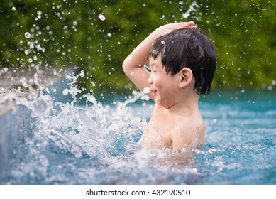 Cute Asian Child Playing In Swimming Pool