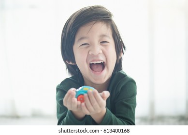 Cute Asian Child Playing Toy Cars
