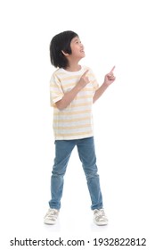 Cute Asian Child Pointing Up With Two Hands On White Background Isolated