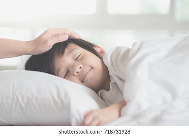 Cute Asian Child Sleeping On White Bed With Mother Care