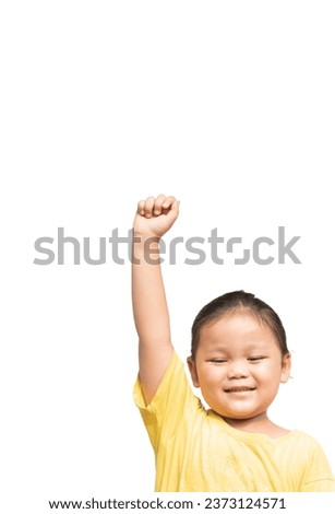 Cute Asian child wearing yellow shirt raising hands on white background