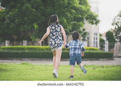 Cute Asian children running together in the park outdoors Stock Photo
