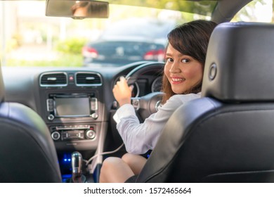 Cute Asian girl in the car smiling e-hailing concept