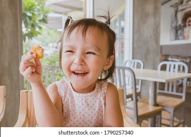 Cute Asian Girl Eating Chicken Nugget By Self. Background. Copy Space.