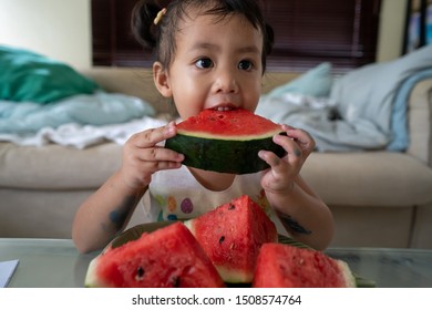 Cute Asian Girl Eating Watermelon.