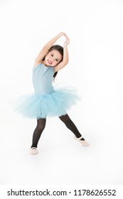 Cute Asian Girl In Light Blue Dress Performing Ballet With Smiling Face, Isolated On White Background.