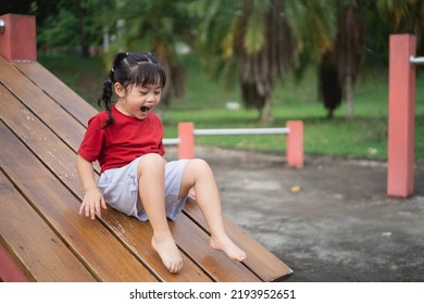Cute asian girl play on school or kindergarten yard or playground. Healthy summer activity for children. Little asian girl climbing outdoors at playground. Child playing on outdoor playground.
