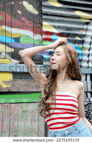 The cute Asian girl posing at the public travel landmark market.