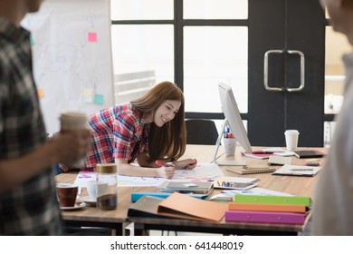 Cute Asian Girl Is Smiling And Writing Master Plan For Meeting At Office.