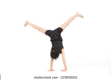 Cute Asian Girl In Sportswear Do A Exercise By Reach Her Hand Forward, Studio Shot On White Background, Copyspace On Right Side. Concept For Kid And Sport Activity.