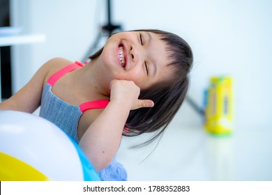 Cute Asian Kid With Autism Playing In Kindergarden With Ball