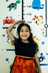 Cute Asian Little Girl Playing With Colorful Fishes On White Board
