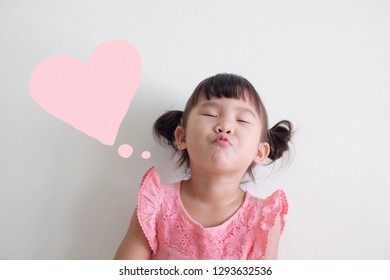 Cute Asian little girl sending kiss  Drawing heart speech bubble  Isolated white background 