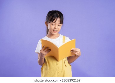 cute asian schoolgirl posing on purple background - Powered by Shutterstock