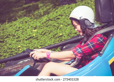 Cute Asian Thai Teen Girl Is Driving Go-kart Car In Playground With Speed In Retro Color