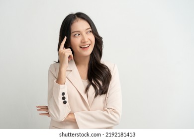 Cute asian woman in color casual dress thinking and imagination isolated on pink background - Shutterstock ID 2192181413