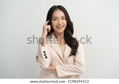 Cute asian woman in color casual dress thinking and imagination isolated on pink background