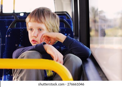 Cute autistic boy sitting in empty bus